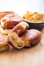 Fried Lenten pies filled with cooked peas inside, on a wooden table.