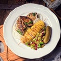 Fried liver with fried potato and salt cucumbers