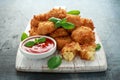 Fried Mac, macaroni and Cheese Bites in breadcrumbs with ketchup sauce on white wooden board Royalty Free Stock Photo