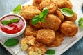 Fried Mac, macaroni and Cheese Bites in breadcrumbs with ketchup sauce on white wooden board Royalty Free Stock Photo