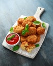 Fried Mac, macaroni and Cheese Bites in breadcrumbs with ketchup sauce on white wooden board Royalty Free Stock Photo
