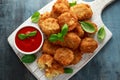 Fried Mac, macaroni and Cheese Bites in breadcrumbs with ketchup sauce on white wooden board Royalty Free Stock Photo