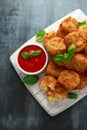 Fried Mac, macaroni and Cheese Bites in breadcrumbs with ketchup sauce on white wooden board Royalty Free Stock Photo