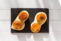 Fried meat balls or croquettes with white sauce on black stone plate on white wooden background. Unhealthy food. Royalty Free Stock Photo