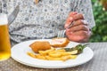 Fried meat in breadcrumbs with french fries on a white plate, Siurana, Catalunya, Spain. Close-up. Royalty Free Stock Photo