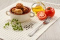 Fried meat cutlets in ceramic soup bowl, red tomatoes, glass bot