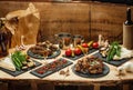 Fried meat, marinated vegetables, potatoes, greens, spetsiin slate black plates and a cognac bottle with two shot Royalty Free Stock Photo