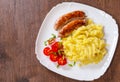 Fried meat sausages with mashed potatoes and vegetables salad Royalty Free Stock Photo