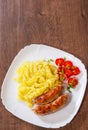 Fried meat sausages with mashed potatoes and vegetables salad Royalty Free Stock Photo