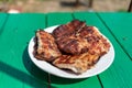 Fried meat steaks on a plate. wasp flew to the meat