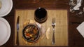 Fried meat and waxes on a dark frying pan on a wooden stand.