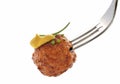 Fried meatball on fork closed up isolated on white