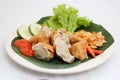 Fried meatball tofu and vegetables on a white plate, Indonesia