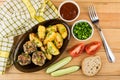 Fried meatballs, baked potatoes, pieces of tomatoes. cucumbers, Royalty Free Stock Photo