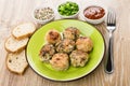 Fried meatballs in green plate, ketchup, green onion, bread