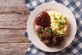 fried meatballs, lingonberry sauce with potato garnish. Horizontal top view Royalty Free Stock Photo