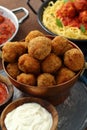 Fried Meatballs in tomato sauce in metal pan on table with italian pasta Royalty Free Stock Photo