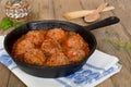 Fried meatballs with tomato sauce and spices in frying pan