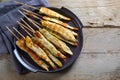 Fried mediterranean chicken skewers served as finger food snack for a festive party, rustic wooden table with copy space, high Royalty Free Stock Photo