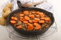 Fried minced meat with sauce and carrots in a pan Royalty Free Stock Photo