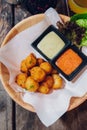 Fried Mozzarella Cheese Balls served with mayonnaise and thousand island sauce in wooden bowl