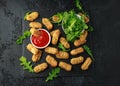 Fried mozzarella cheese sticks in breadcrumbs with ketchup sauce and wild rocket leaves Royalty Free Stock Photo