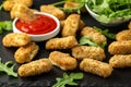 Fried mozzarella cheese sticks in breadcrumbs with ketchup sauce and wild rocket leaves Royalty Free Stock Photo