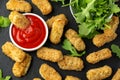 Fried mozzarella cheese sticks in breadcrumbs with ketchup sauce and wild rocket leaves Royalty Free Stock Photo