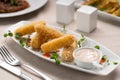 fried mozzarella cheese sticks breaded serving on white plate with garlic sauce Royalty Free Stock Photo