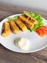 Fried mozzarella cheese sticks breaded on white plate Royalty Free Stock Photo