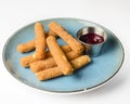 Fried Mozzarella Sticks with Marinara Sauce served on a light blue plate over white background. Isolated on white. Royalty Free Stock Photo