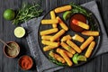 fried mozzarella sticks with sauce on black plate Royalty Free Stock Photo