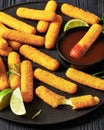 fried mozzarella sticks with sauce on black plate Royalty Free Stock Photo