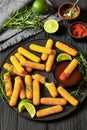 fried mozzarella sticks with sauce on black plate Royalty Free Stock Photo