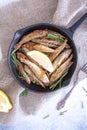 Fried mullet with rosemary and lemon in a pan