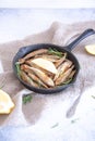 Fried mullet with rosemary and lemon in a pan