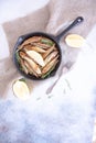 Fried mullet with rosemary and lemon in a pan