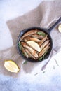 Fried mullet with rosemary and lemon in a pan