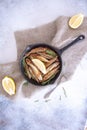 Fried mullet with rosemary and lemon in a pan