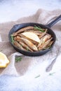 Fried mullet with rosemary and lemon in a pan