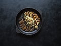 Fried mushrooms on a cast iron pan on a black kitchen table. The view from the top. Royalty Free Stock Photo