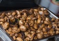 Fried mushrooms champignons in an iron tray