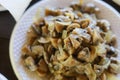 Fried mushrooms on a fire in a disposable plastic plate in the dark of an evening dinner in nature. Selective focus Royalty Free Stock Photo