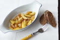Fried new potatoes in oval pan on the table Royalty Free Stock Photo