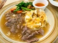 Fried noodle mixed with egg in beef gravy sauce serving on plate Royalty Free Stock Photo