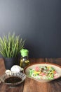 Fried noodle rice vermicelli in a plate with soy sauce on a wooden table.