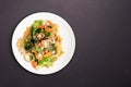 Fried noodle with seafood and vegetable in round white dish isolated on white background. Thai Food concept Royalty Free Stock Photo