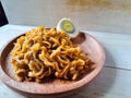 Fried noodles with boiled egg pieces on a wooden plate Royalty Free Stock Photo
