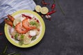 Fried noodles put in a plate ready to serve With lime shrimp lemongrass shallot coriander spring onion and chili on a black table Royalty Free Stock Photo