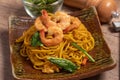 Fried noodles with shrimp in a plate on the table Royalty Free Stock Photo